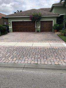 Driveway before pressure cleaning services in Pompano Beach